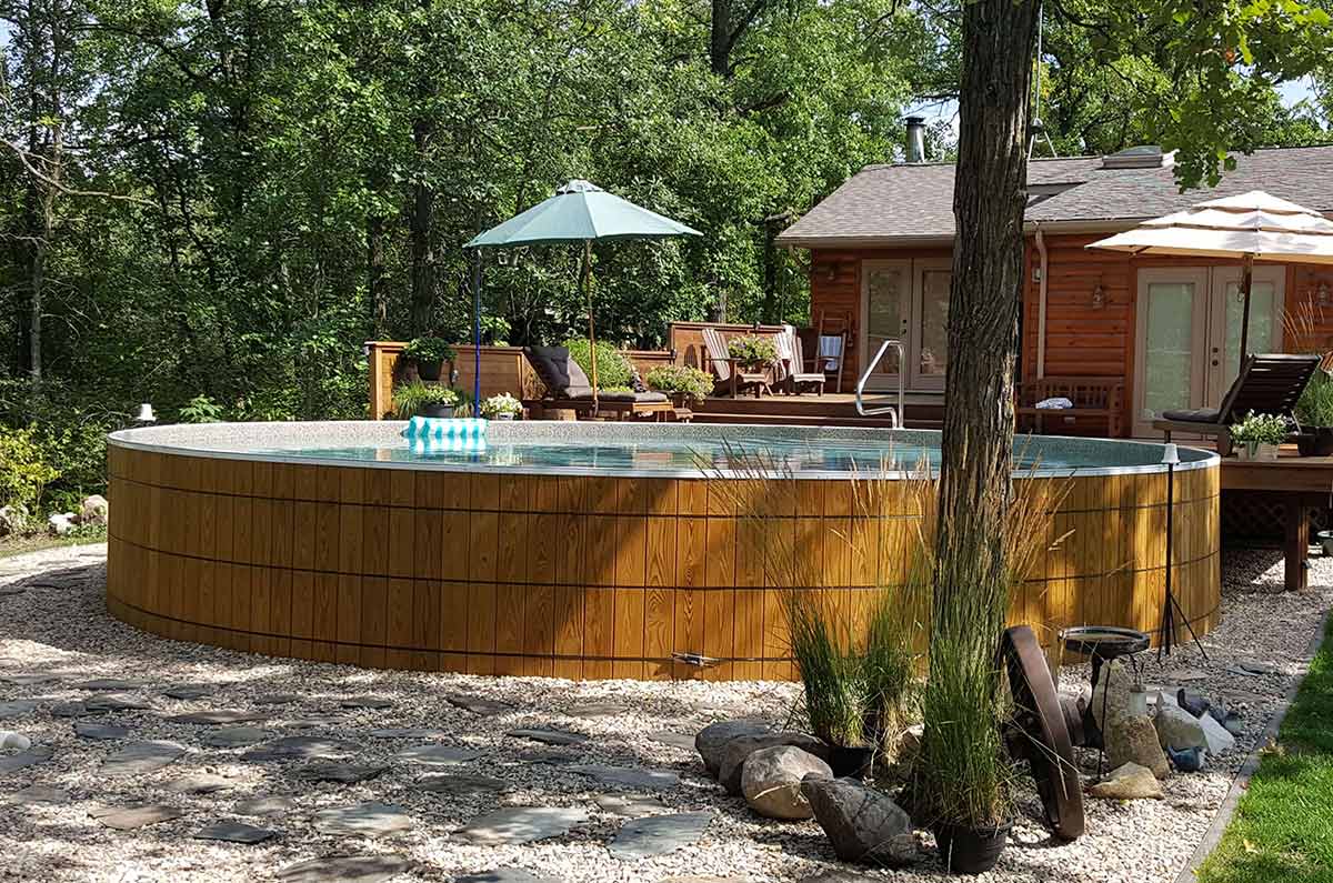wooden round above ground pool with walk-in stairs