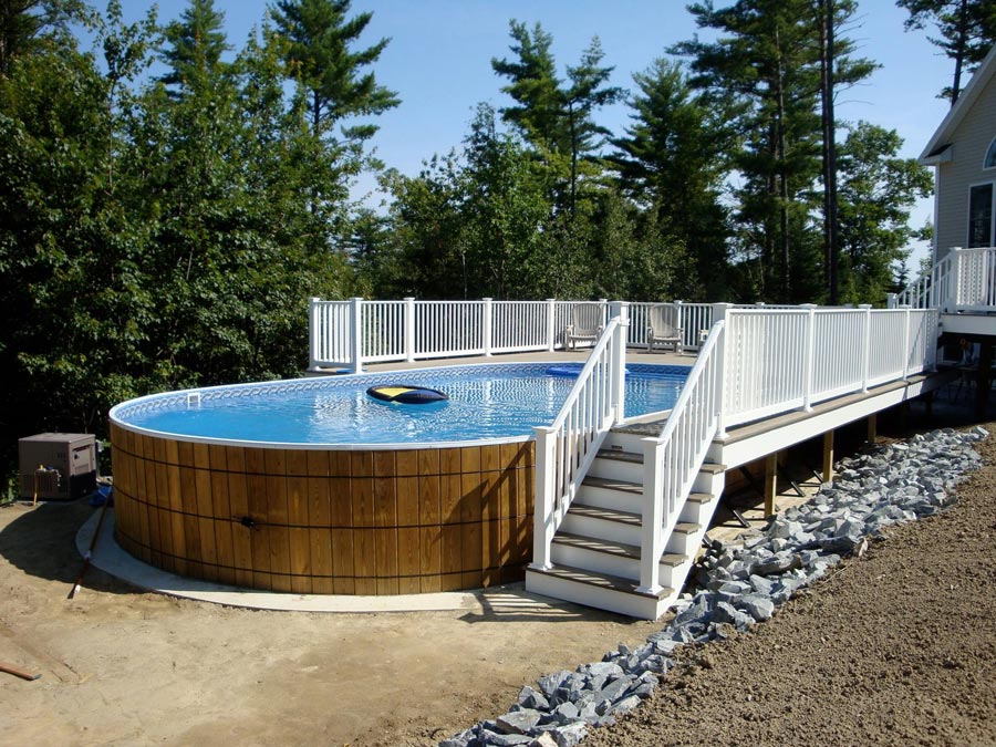 wooden oval above ground swimming pool with patio