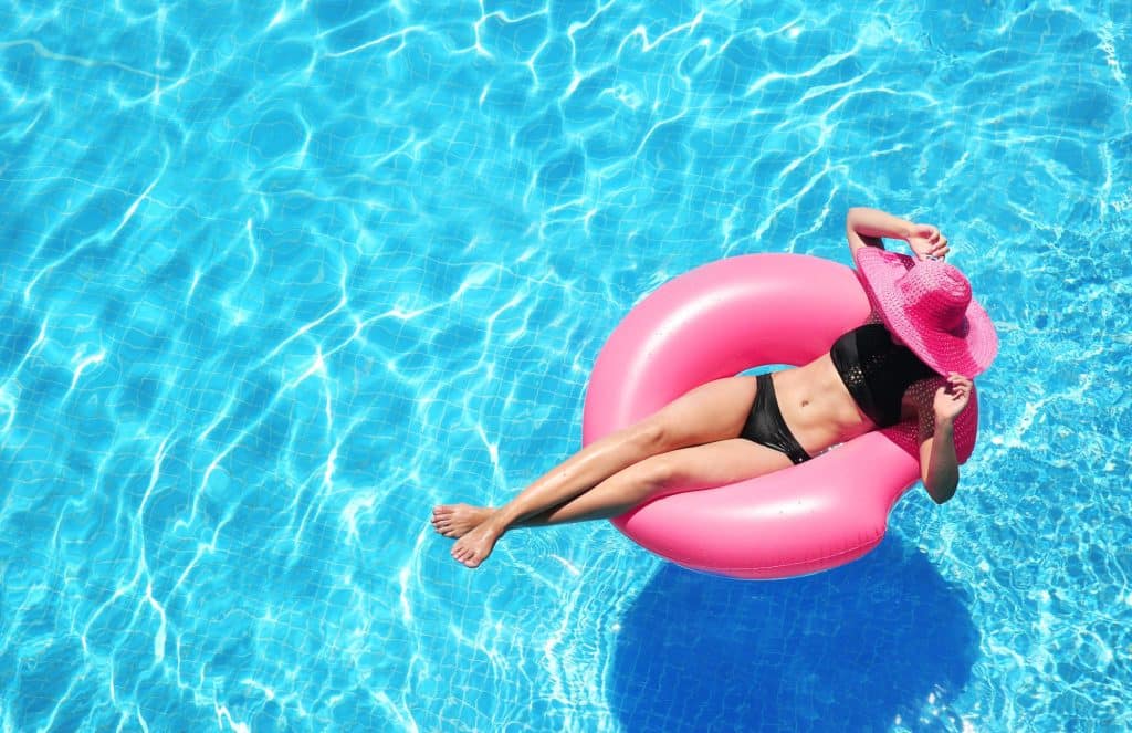 woman floating on an inner tube in a swimming pool